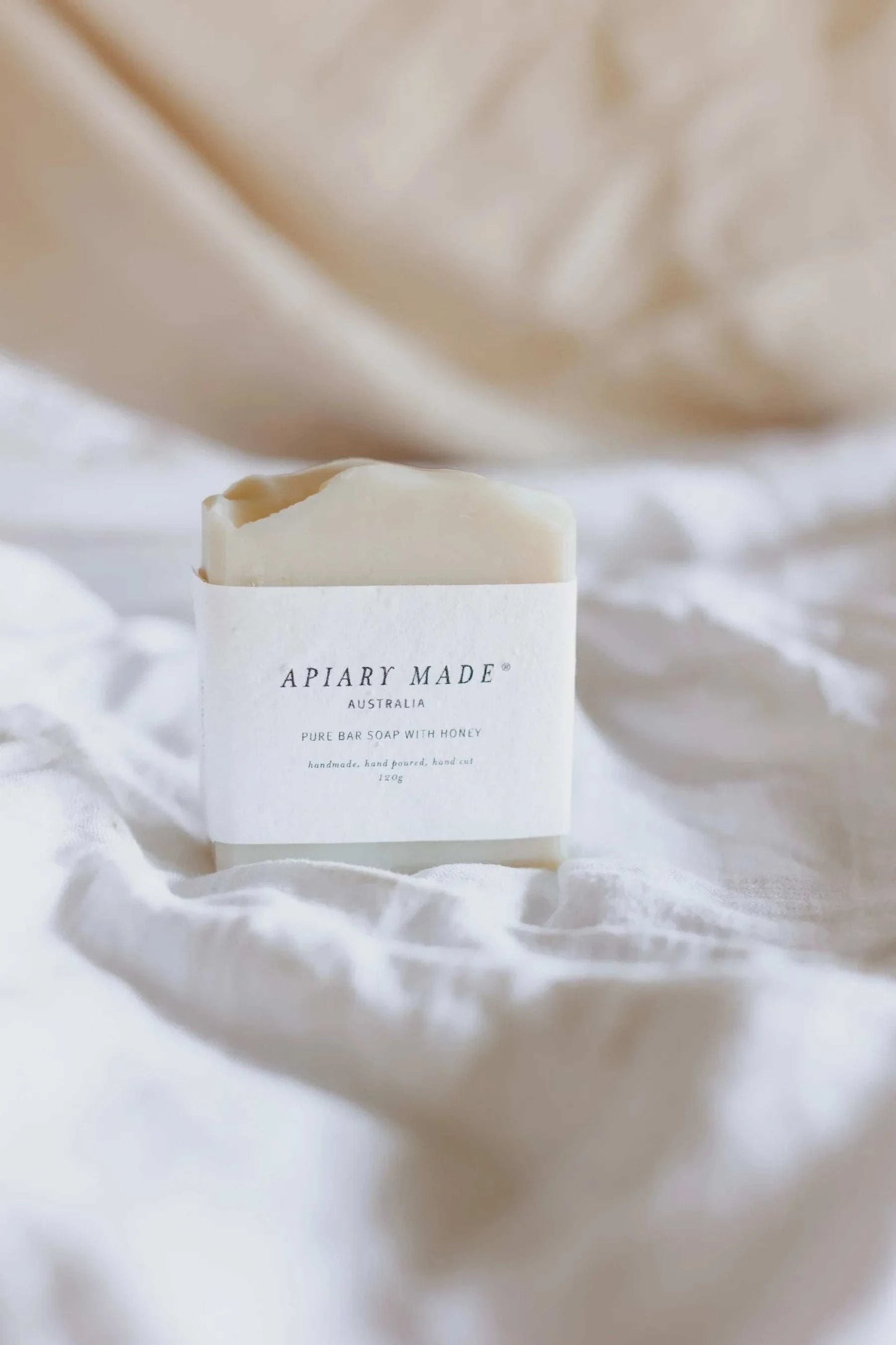 Apiary Made - Pure Bar Soap on a white fabric background.