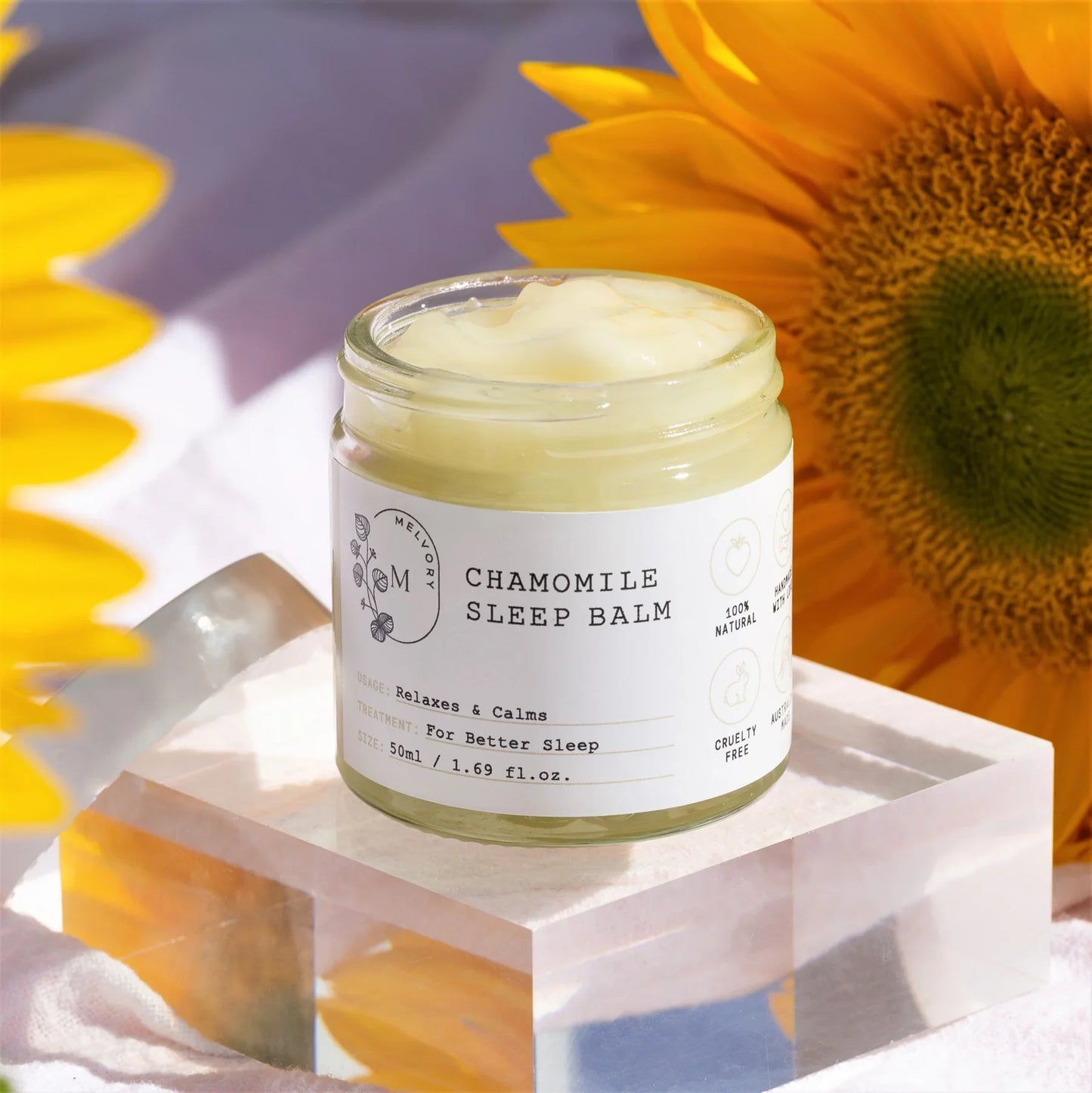 Melvory Chamomile Sleep Balm in eco jar surrounded by sunflowers.