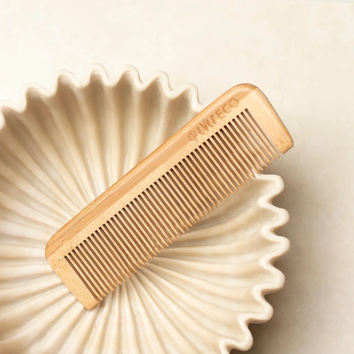 Eco-friendly fine tooth bamboo comb for smoothing and styling.