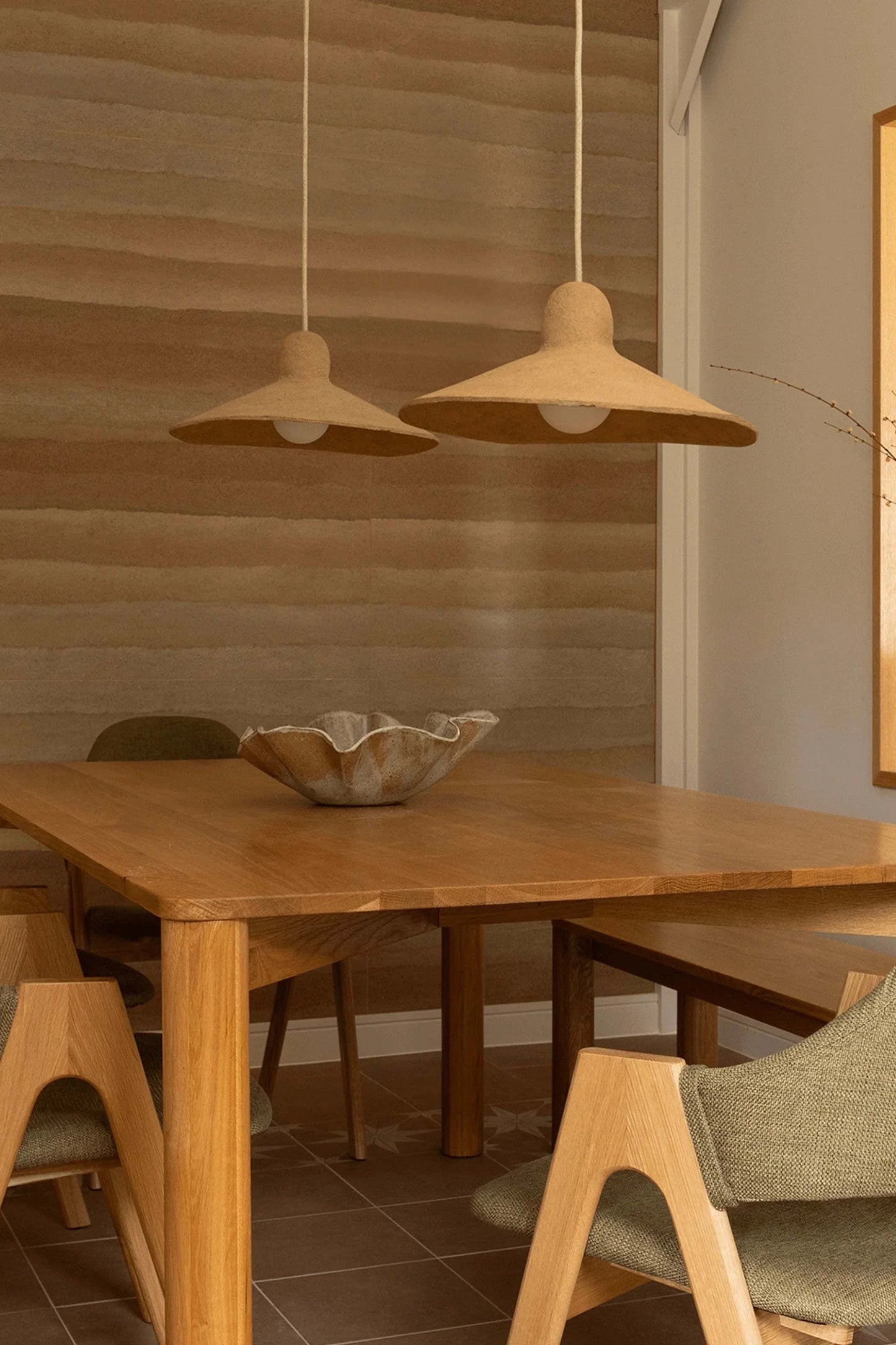 Ripple Pendant Light made from magazine waste and coffee grounds in a modern dining setting.