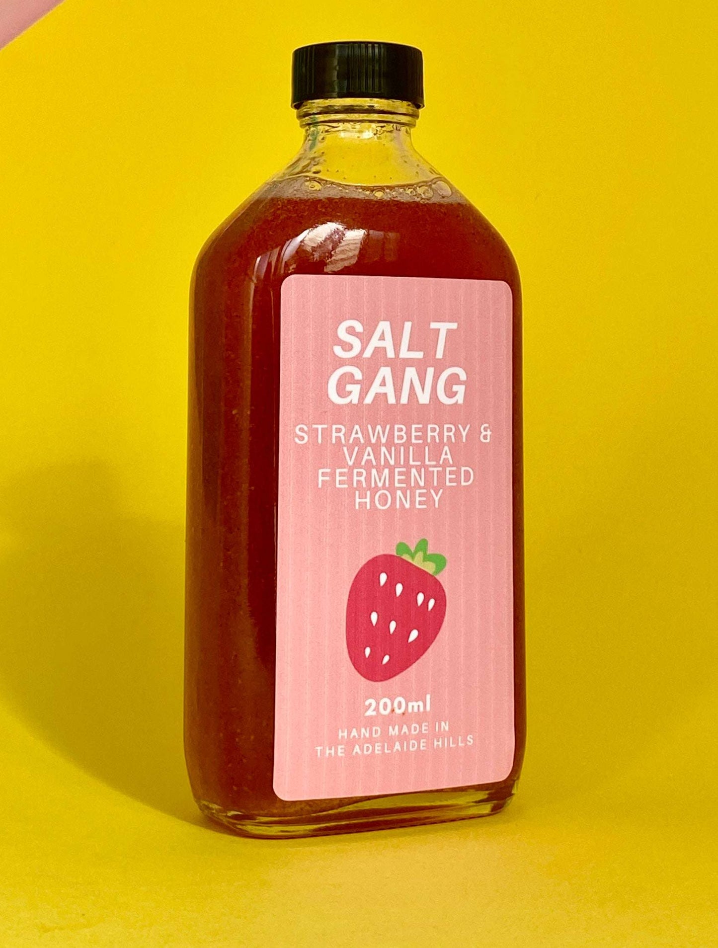 Salt Gang Strawberry and Vanilla Fermented Honey in 200ml glass jar on yellow background.