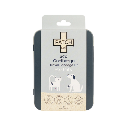 Eco-friendly travel bandage kit for pets, including wrap bandages and gauze pads in a refillable tin.