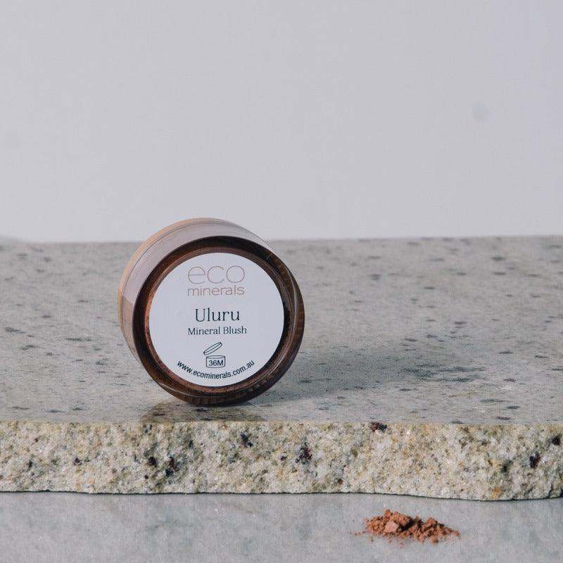 Eco Minerals Mineral Blush in Uluru shade on stone surface.