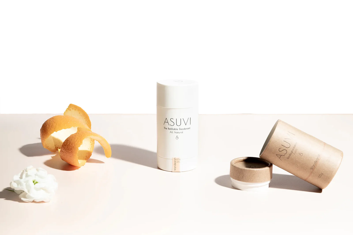 Asuvi deodorant in white tube with biodegradable packaging and orange peel.