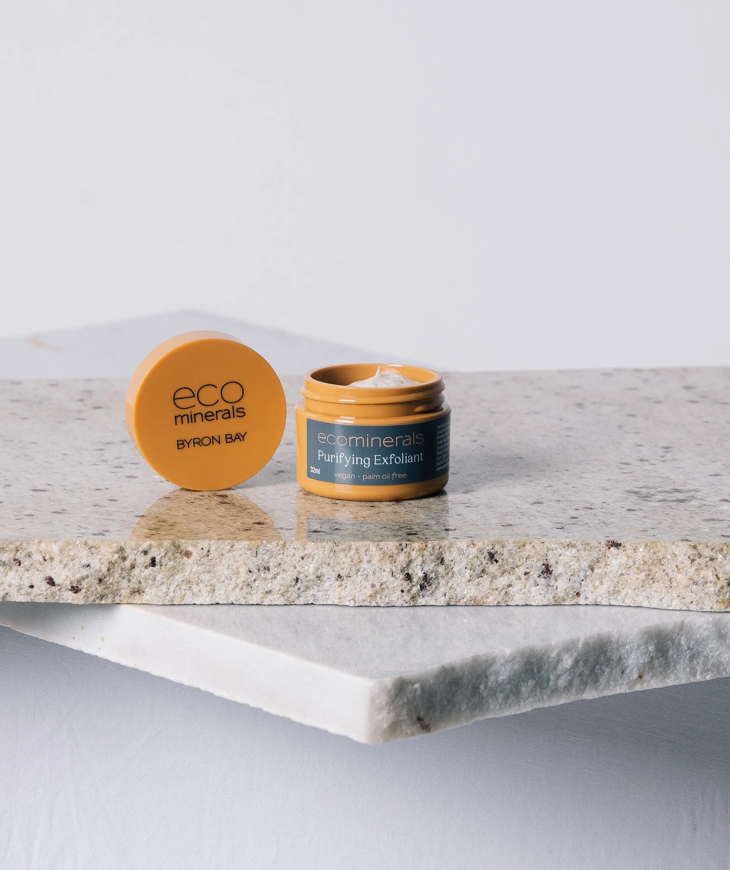 Eco Minerals Purifying Exfoliant jar on a stone slab.