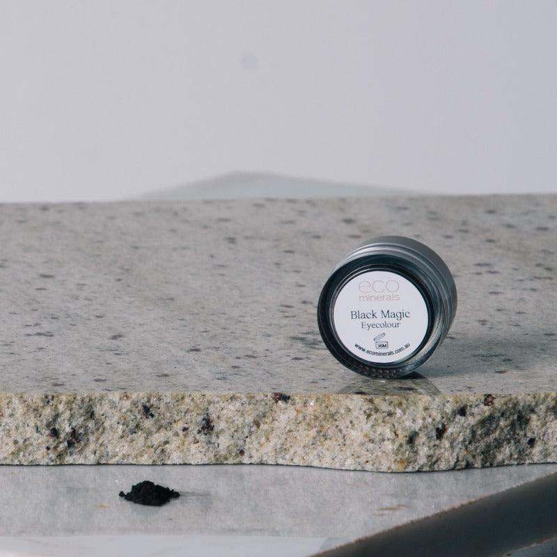 Eco Minerals - Black Magic Eyeliner Powder on stone surface.