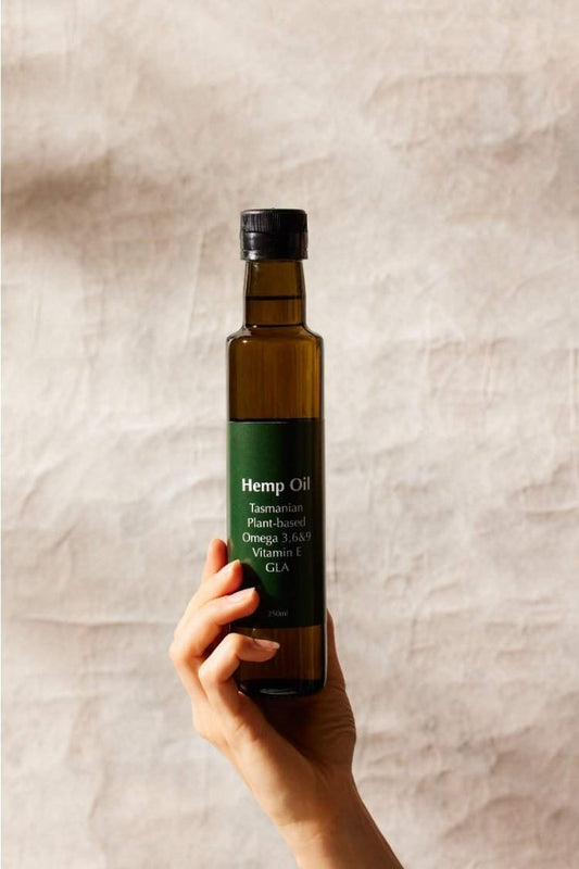Hemp seed oil bottle, rich in omega fatty acids and vitamins, labeled Tasmanian origin.