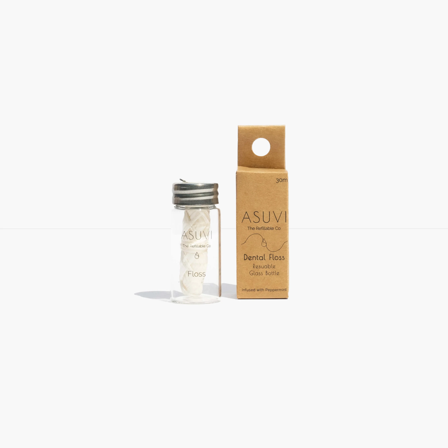 Eco-friendly Asuvi dental floss in reusable glass bottle with compostable refills, natural mint scent.