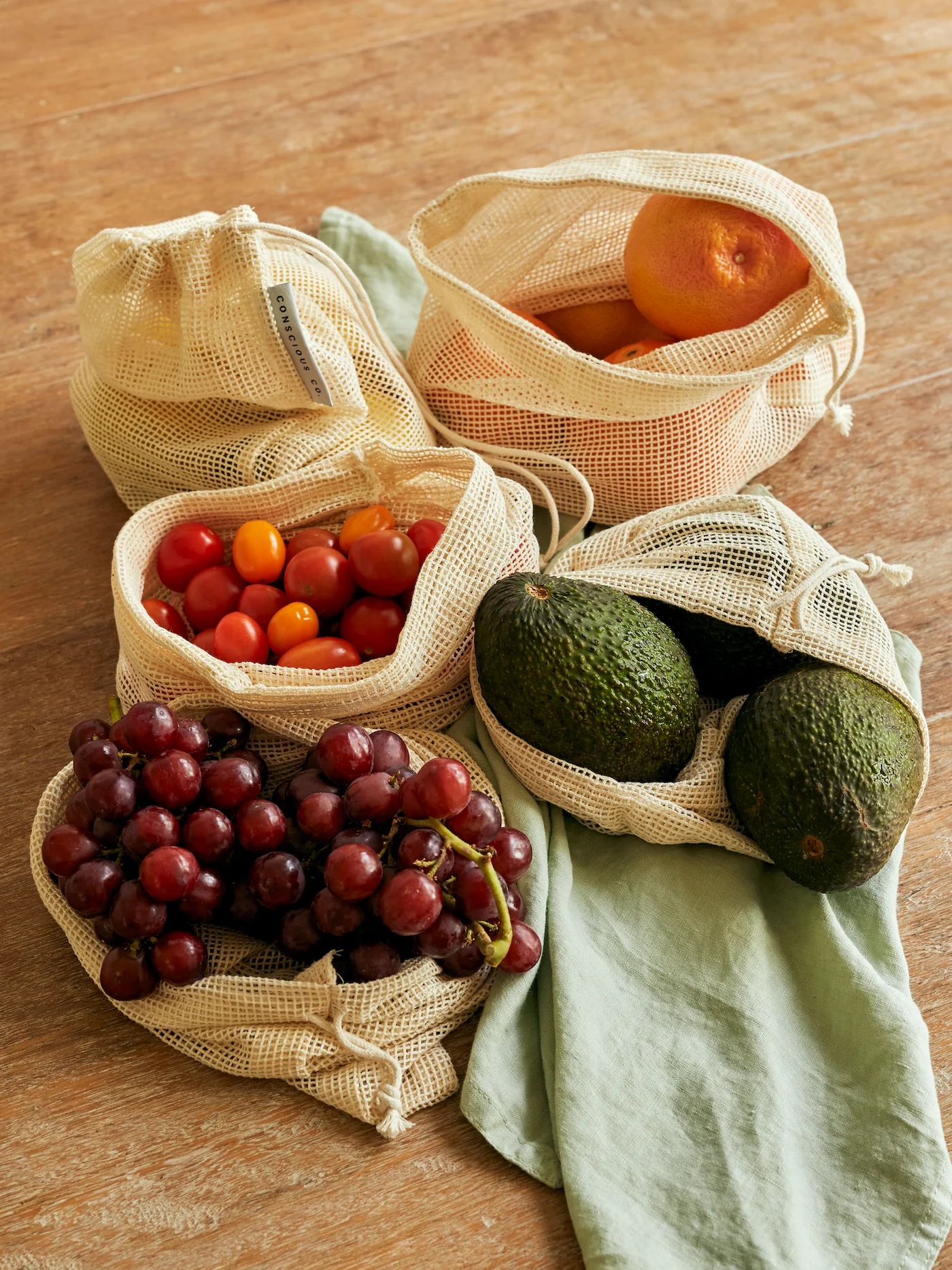 Organic cotton mesh grocery bags filled with fruits and vegetables.