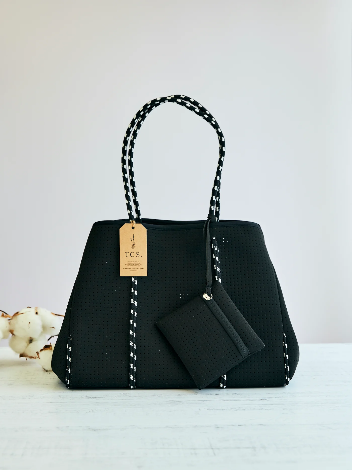 Conscious Store - Recycled Neoprene Tote Bag in black with small internal purse and press studs, eco-friendly fashion accessory.