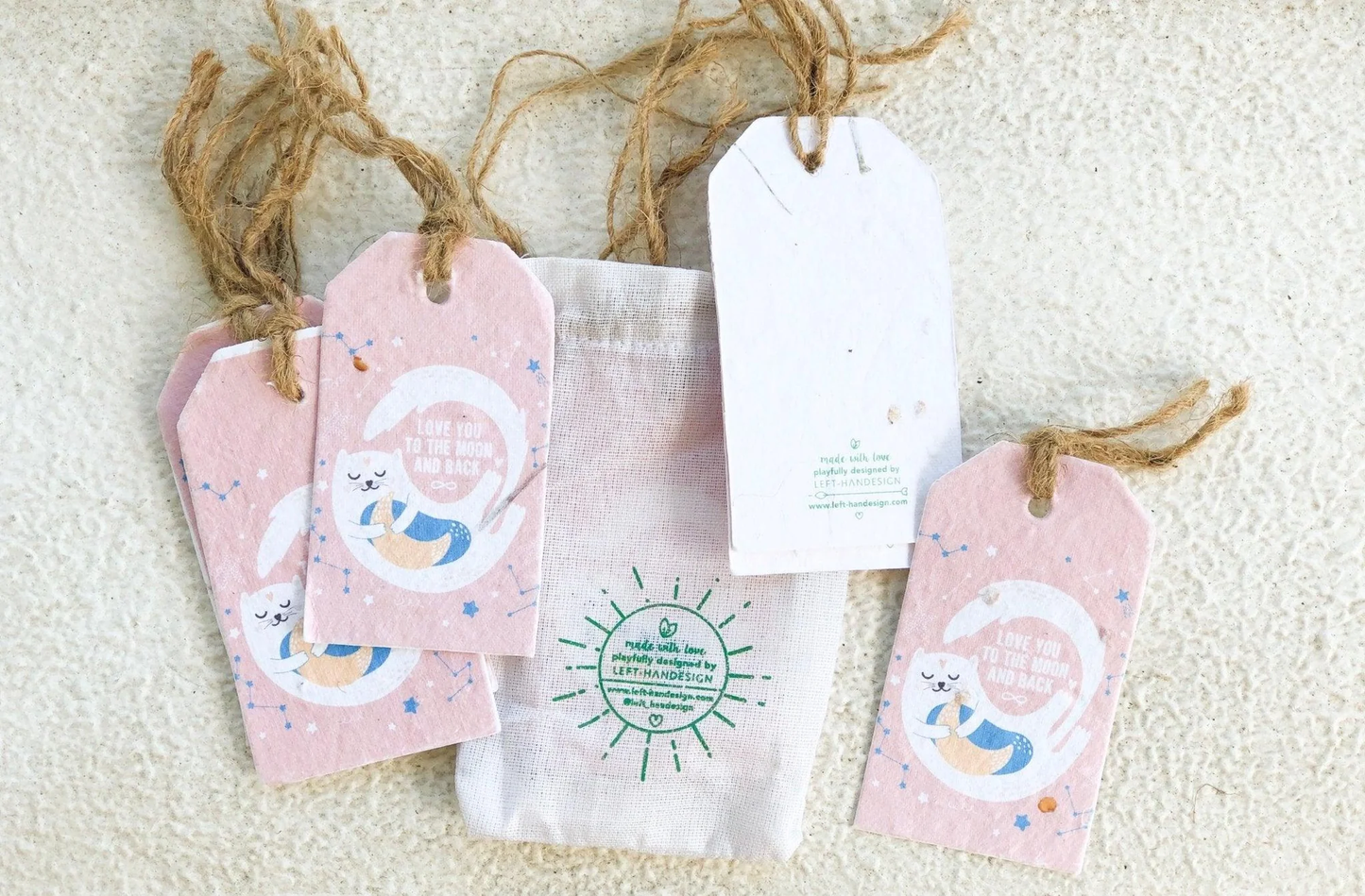 Left-Handesign plantable gift tags with pink moon design, eco-friendly seed paper.