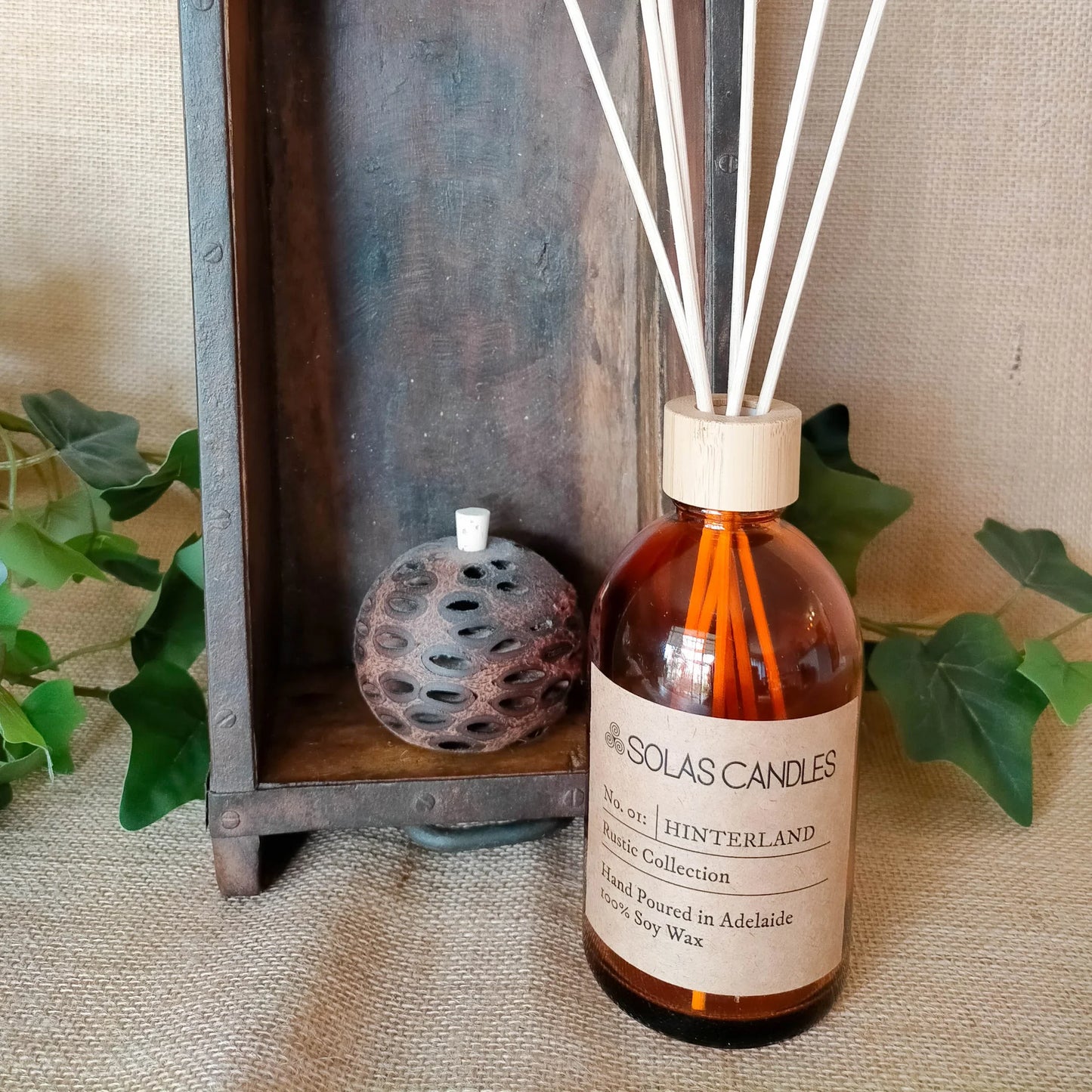 Solas Candles - Rustic Collection, No.01 Hinterland with fresh herbaceous scent displayed next to decorative elements.