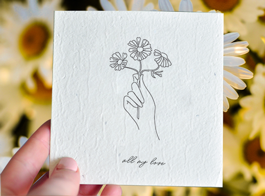 Eco-friendly plantable card with swan river daisies, 100% recycled material, "All my love" text.