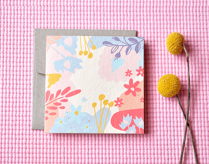 Nurturing Nature Cards with colorful floral design and recycled envelope on pink textured background
