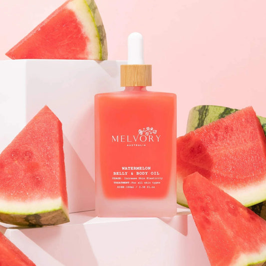 Melvory Watermelon Belly Oil with natural ingredients for skin elasticity, surrounded by watermelon slices.