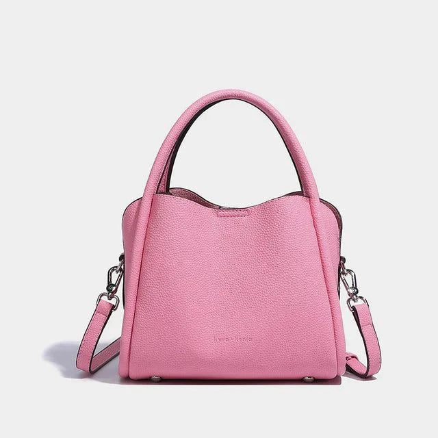 Pink Kyra + Kenja Leah Crossbody bag in pebble vegan leather with adjustable shoulder strap.